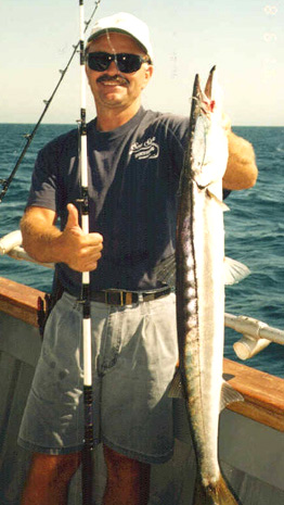 Charter boat fishing Oceanside, CA Captain Joe holding a big fish